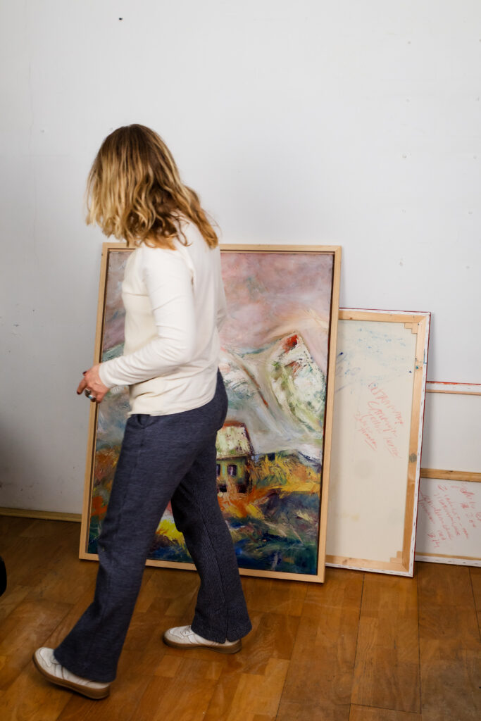 art series - Artist in studio. Leonoor Ruigrok viewing an original painting in the studio while choosing artwork for a home