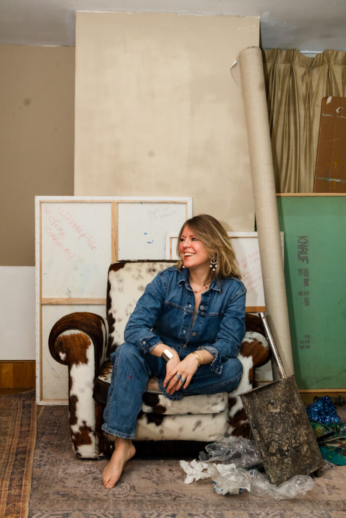 Female visual artist Leonoor Ruigrok in studio. Artist material and paintings