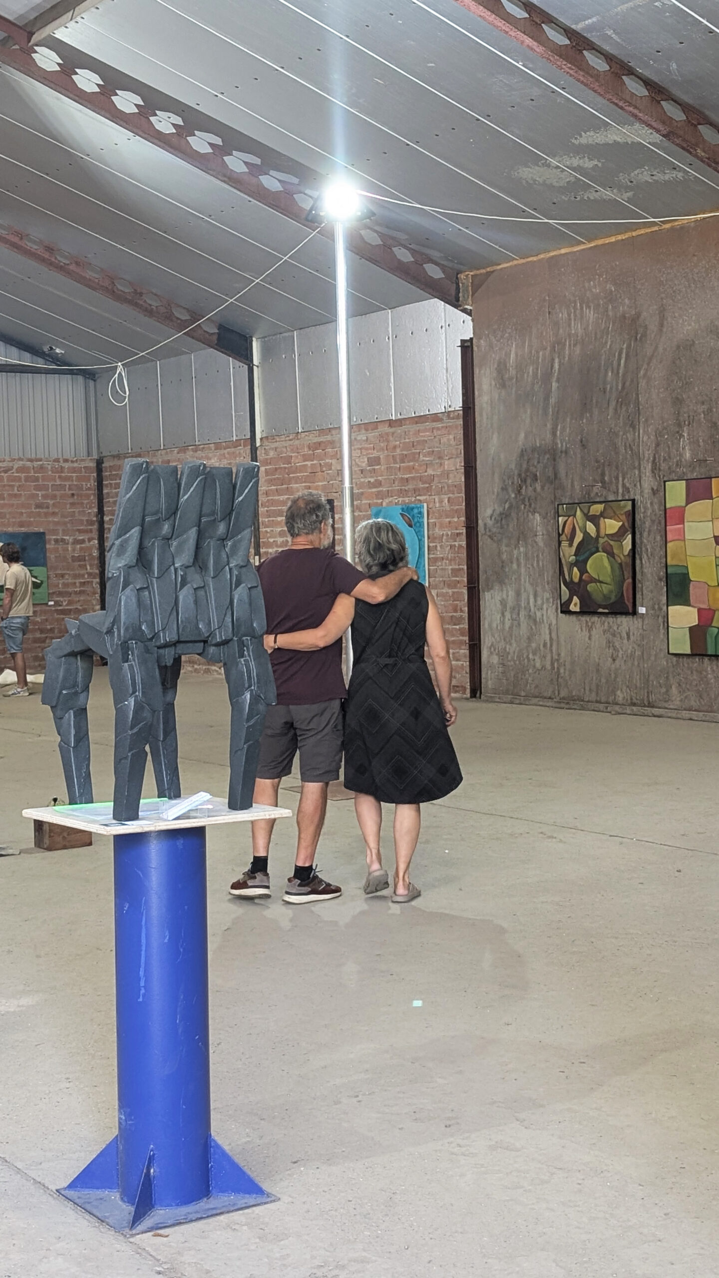 Visitors observing contemporary artworks during Kunstschouw Zeeland exhibition