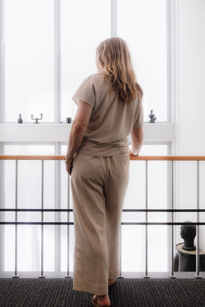 Artist Leonoor Ruigrok looking out from a quiet studio environment, reflecting on artists’ networks, collectives and professional art practice.