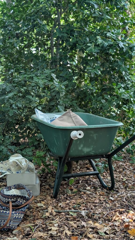 Outdoor studio workspace on Leonoor Ruigrok’s land, with painting materials, plants and natural textures around the working area.