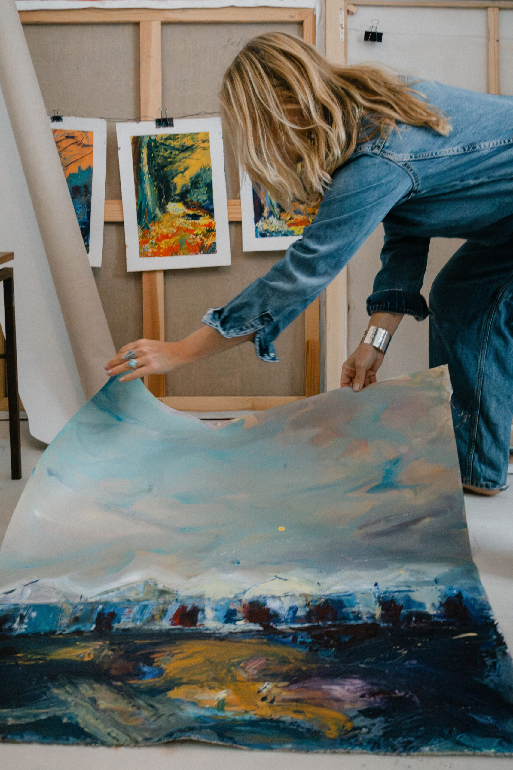 Leonoor Ruigrok working on a large colourful painting in her art studio