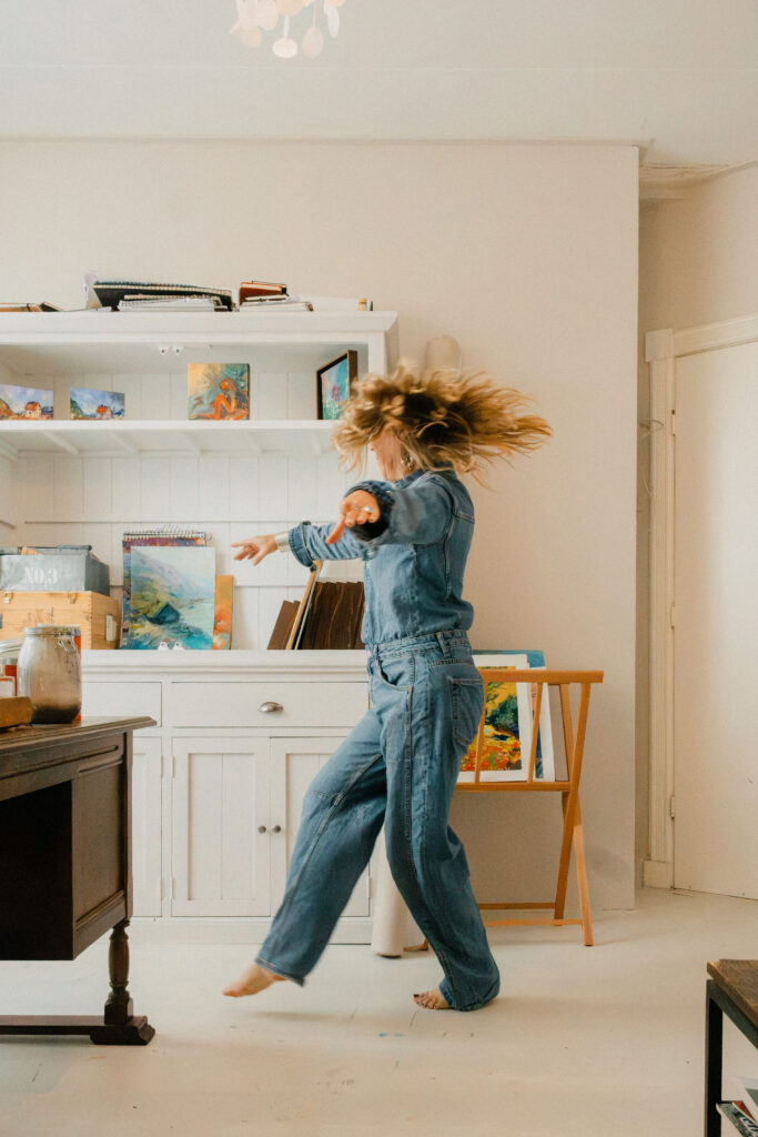 Leonoor Ruigrok walking through her art studio in Voorhout, surrounded by paintings.